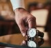 Hand of a man picking up a watch